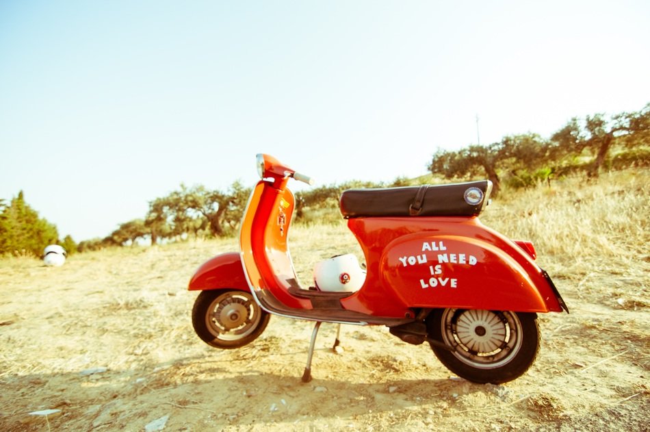 red moped in the middle of summer