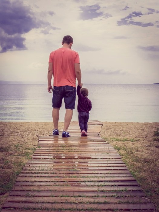 father and child near the sea