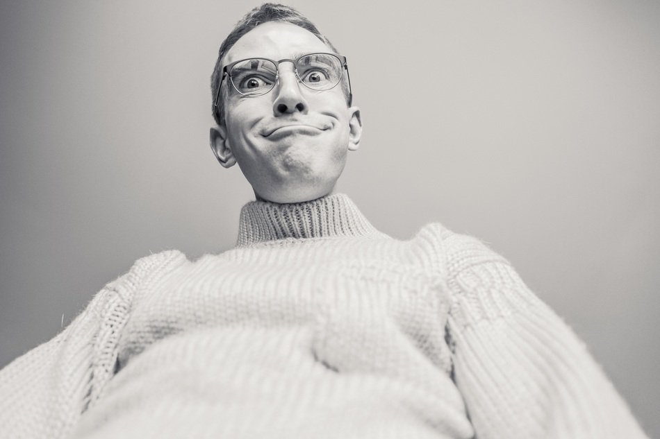Funny man in glasses in white pullover