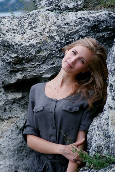 girl posing at the stone