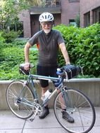 photo of an elderly man with a bicycle