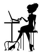 silhouette of a girl working on a laptop at a table