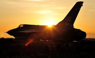 photo of a fighter against the background of dawn