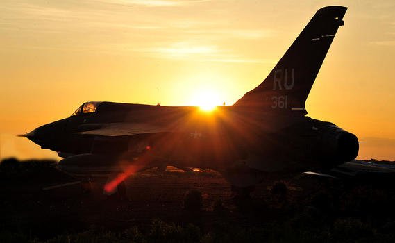 photo of a fighter against the background of dawn