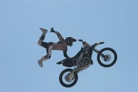 motorcycle stunt under the blue sky