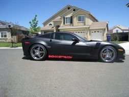 Satin Black sports Auto at suburban house