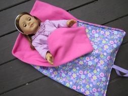 the doll lies in a blanket