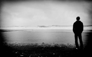 silhouette of a sad man on the shore as a picture for clipart