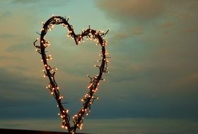 the construction of the heart of the garland on the evening landscape