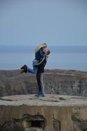 loving couple on the rock romantic scene