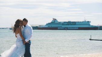 couple in love on the pier on the background of the ferry