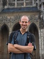 smiling man with backpack