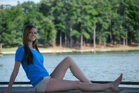 happy girl posing by the lake