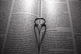 wedding ring on a religious book
