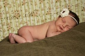 Newborn sleeping on a bed