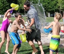 happy people are playing water fight