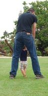 father with baby on green lawn