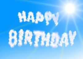 phrase "happy birthday" in the rays of the bright sun