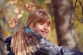 Smiling Girl blond long hair autumn
