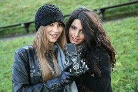 girls with a camera on a green meadow