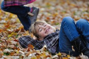happy girl on autumn leaves