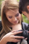 girl examines the photo on camera