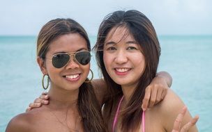 portrait of young women girlfriends on the background of the sea