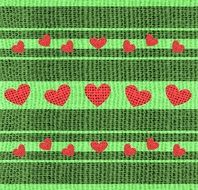 Red hearts on a green textile