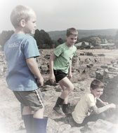 children are playing on the rocky beach