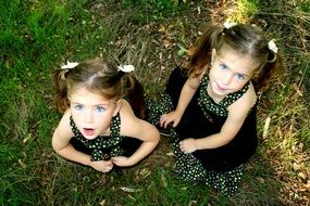 top view of a blue-eyed twin sisters