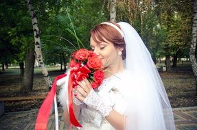 bride with a bouquet of red roses