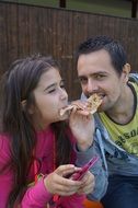 father and daughter eating pancake