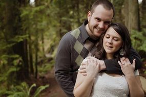 engaged couple in forest