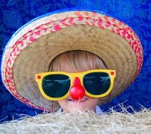 baby in glasses and straw hat