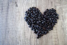 Heart made of the coffee beans on the table