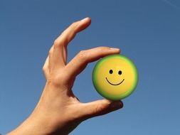 smiley on the ball in man's hand