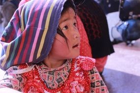 girl in a striped hat in Nepal