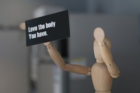 wooden figure with message love your body