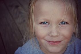 photo of a smiling girl with white hair