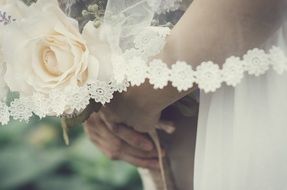 white rose in the hands of the bride