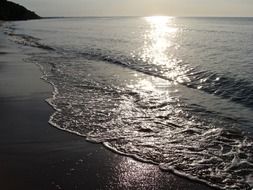 water on the beach in the evening