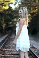 girl in white on a railway track