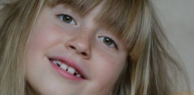 beautiful face of a little girl with freckles