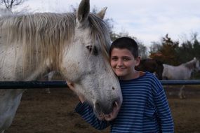 White horse boy love animals