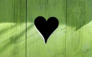 symbol of a heart on a wooden door