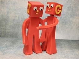 figures resembling embracing friends