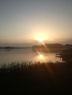 golden sun over the lake at sunrise