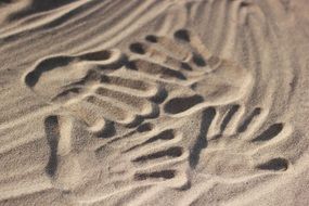 handprints in the sand