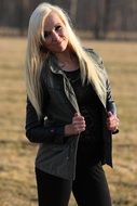 blonde in a leather jacket in the park