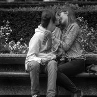 young people kiss on the bench